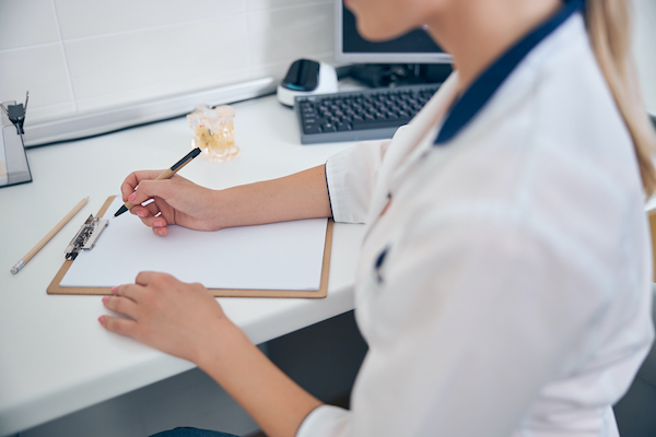 woman in medical uniform writing at desk 2021 09 03 21 03 11 utc